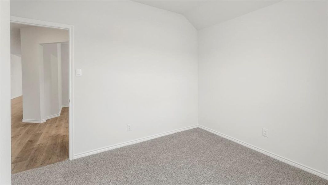 Neutral white walls and light gray carpet create a bright interior