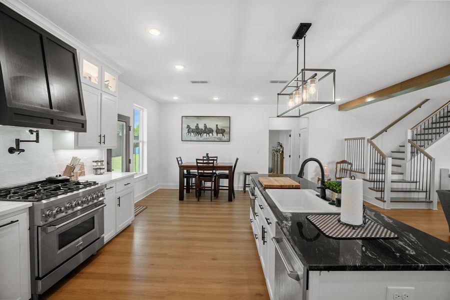 Kitchen featuring stainless steel appliances, a sink, recessed lighting, backsplash, and an island with sink Kitchen featuring stainless steel appliances, a sink, recessed lighting, backsplash, and an island with sink