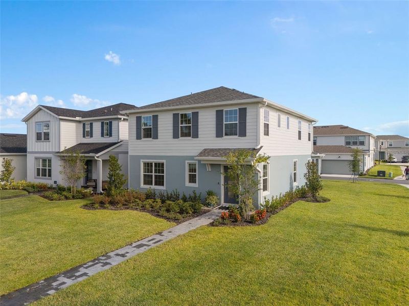 Front exterior of a new home in EverBe, Orlando, FL, highlighting curb appeal (Image 1). Front exterior of a new home in EverBe, Orlando, FL, highlighting curb appeal (Image 1).