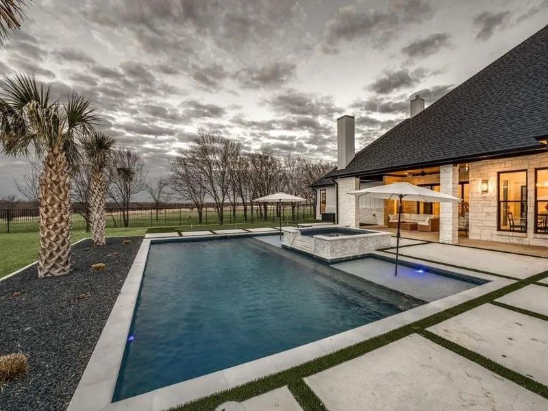 View of pool featuring a patio and a pool with connected hot tub