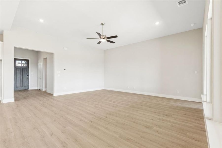 Carpeted spare room featuring baseboards and lofted ceiling Carpeted spare room featuring baseboards and lofted ceiling