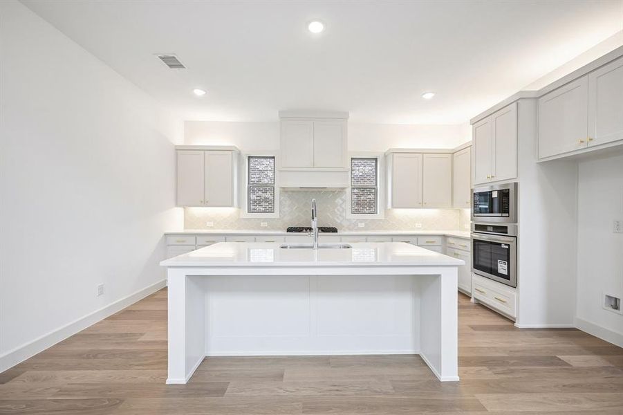 The spacious island is the hub of your new dream kitchen!