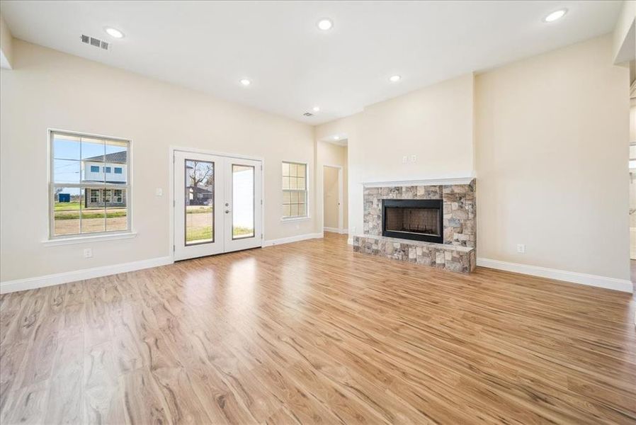 Unfurnished living room featuring a fireplace and light hardwood / wood-style floors