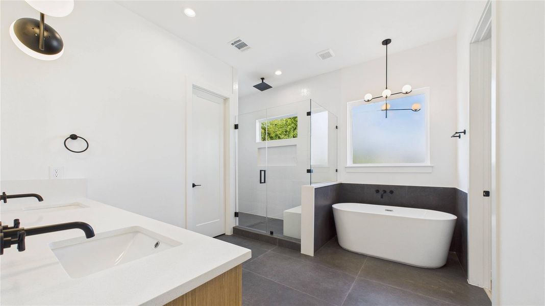 Primary - Soaking tub and glass wall shower