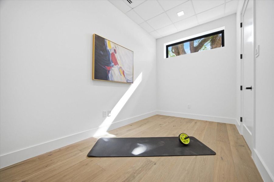 A light-filled flex space designed for wellness—ideal for a private gym, yoga studio, or personal retreat.