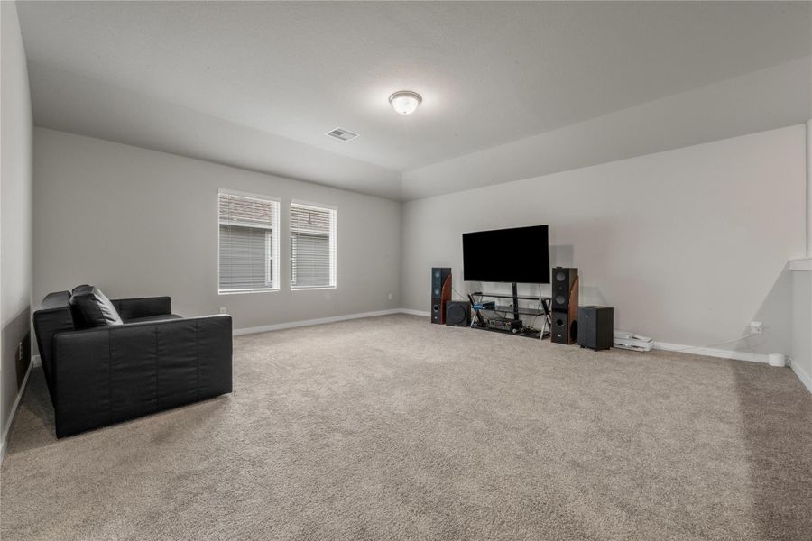 Spacious and light-filled living area designed for comfort and everyday living. The open layout provides ample room for seating and entertainment, with large windows that allow natural light to flow throughout the space.