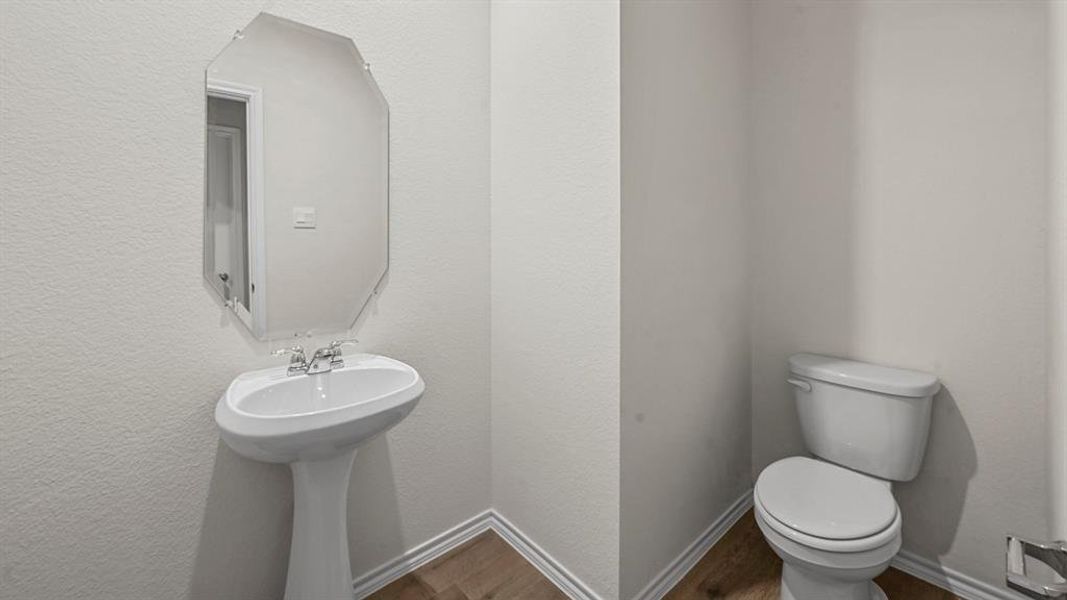 Pedestal sink with an octagonal mirror and chrome faucet