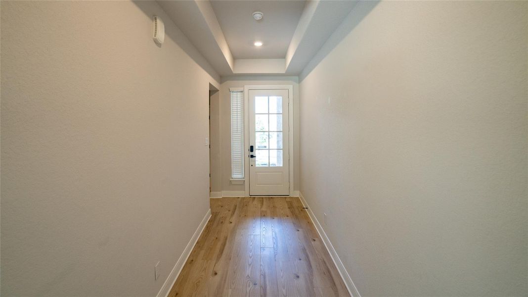 Doorway to outside with hardwood / wood-style floors and recessed lighting Doorway to outside with hardwood / wood-style floors and recessed lighting