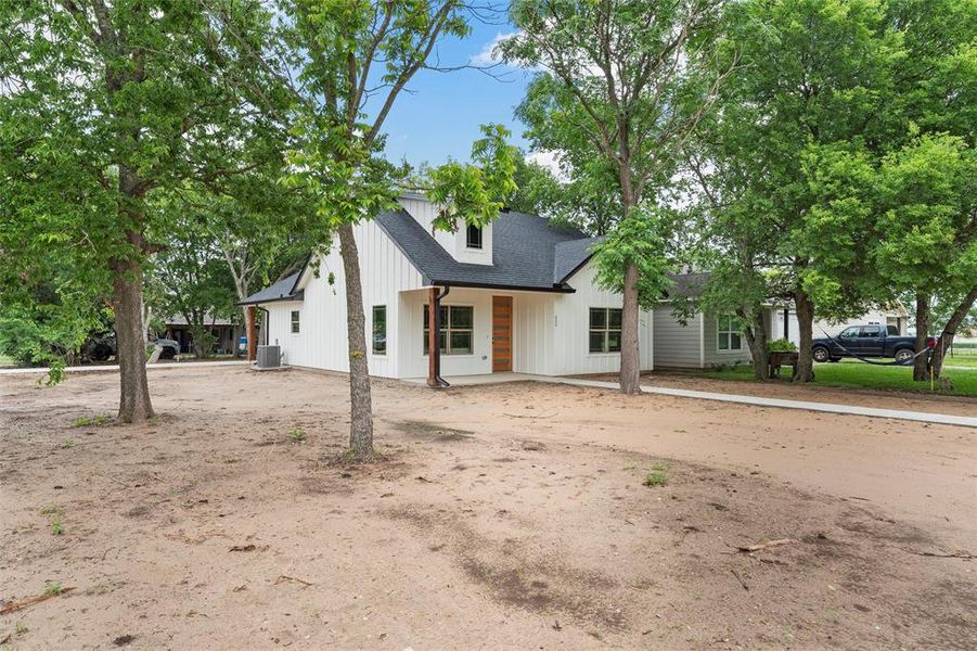Modern farmhouse featuring central AC and a shingled roof
