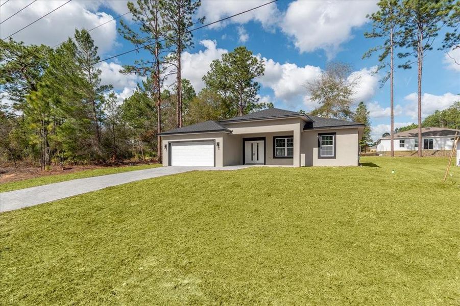 Front exterior of a new home in , Citrus Springs, FL, highlighting curb appeal (Image 29).