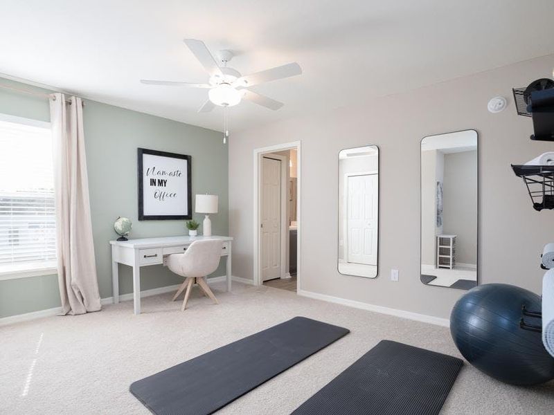 Or, for flexible uses such as this combination yoga room and office - Magnolia townhome by Highland Homes Or, for flexible uses such as this combination yoga room and office - Magnolia townhome by Highland Homes