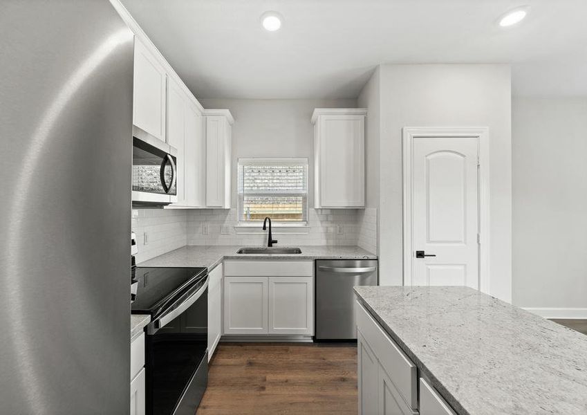 The kitchen of the Sabine floor plan has white wood cabinetry.