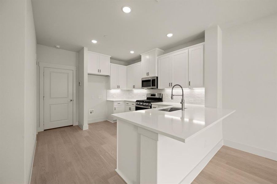 The kitchen peninsula offers a great place for a quick bite or homework station.