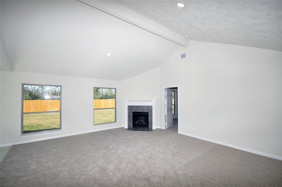 Family Room ceiling soars and the remotely controlled gas fireplace is a standard at Cervelle Homes.