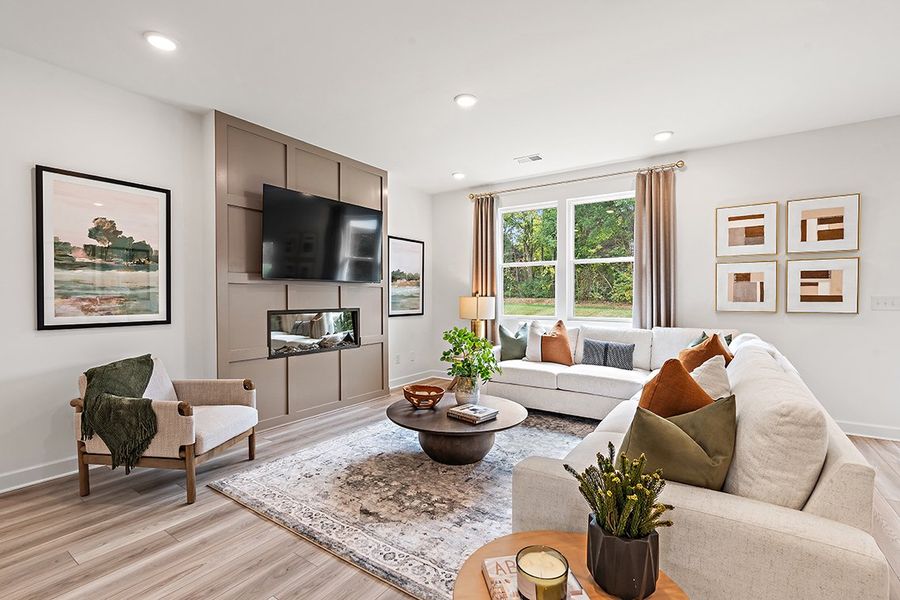 A living room with a tv and couches. A living room with a tv and couches.