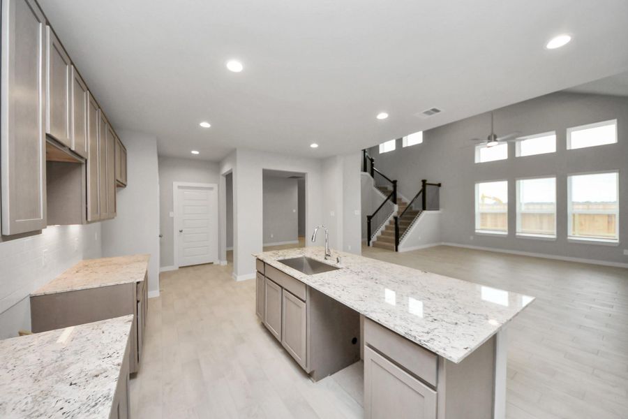 All of this overlooks your expansive family room, creating a perfect space forculinary delights and family gatherings. Sample photo of completed home with similar floor plan. Actual colors and selections may vary. All of this overlooks your expansive family room, creating a perfect space forculinary delights and family gatherings. Sample photo of completed home with similar floor plan. Actual colors and selections may vary.