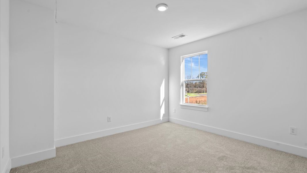 Vibrant and restful bedroom with oversized windows, refined detail, and a warm, welcoming atmosphere