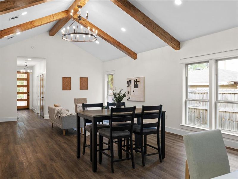 Dining area with suspended lighting and dark wood-style floors