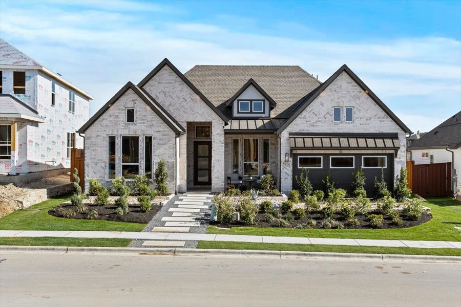 Front exterior of a new home in Lariat, Liberty Hill, TX, highlighting curb appeal (Image 2).