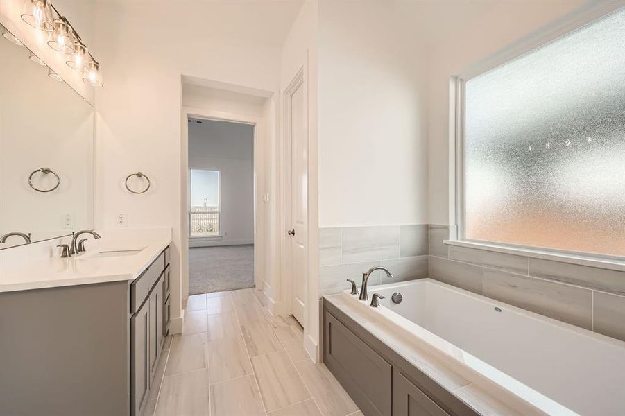 Bathroom with vanity and a tub