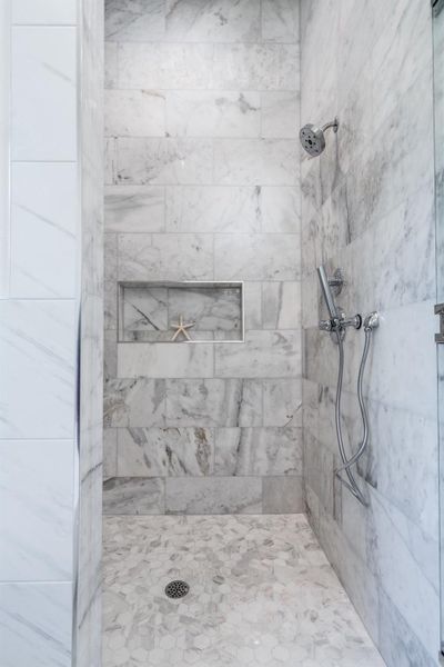 Elegant walk-in shower in the primary bathroom Elegant walk-in shower in the primary bathroom