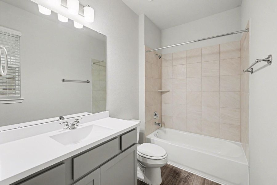 Secondary bathroom with single vanity and tub shower combination Secondary bathroom with single vanity and tub shower combination