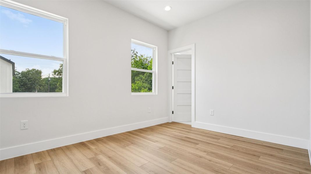 Unfurnished room with wood finished floors and recessed lighting Unfurnished room with wood finished floors and recessed lighting