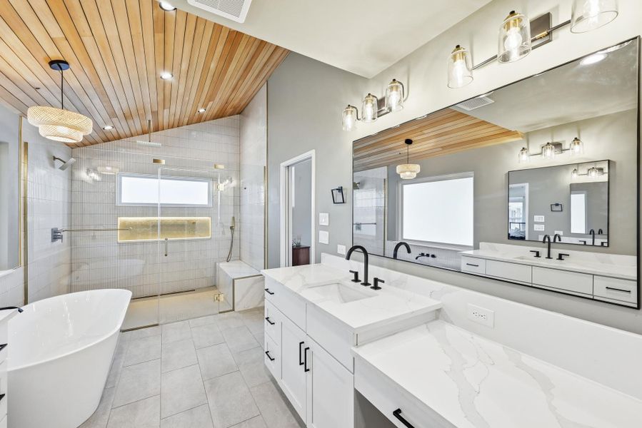 Full bath featuring a soaking tub, a shower stall, double vanity, a vaulted wood ceiling, and recessed lighting