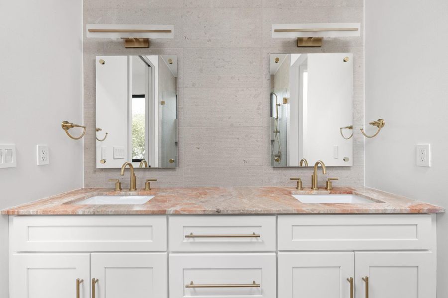Full bathroom featuring double vanity and decorative backsplash