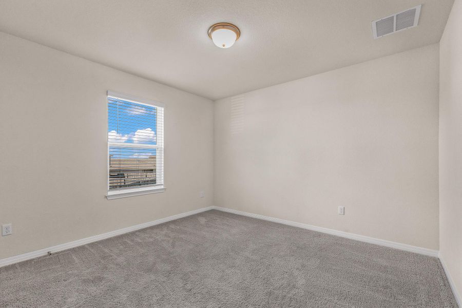 Carpeted spare room with baseboards Carpeted spare room with baseboards