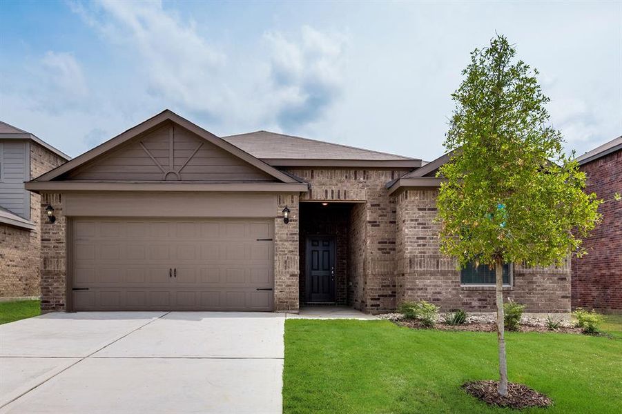 View of front of house with a garage and a front yard