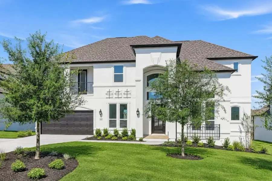 Front exterior of a new home in Travisso, Leander, TX, highlighting curb appeal (Image 2). Front exterior of a new home in Travisso, Leander, TX, highlighting curb appeal (Image 2).