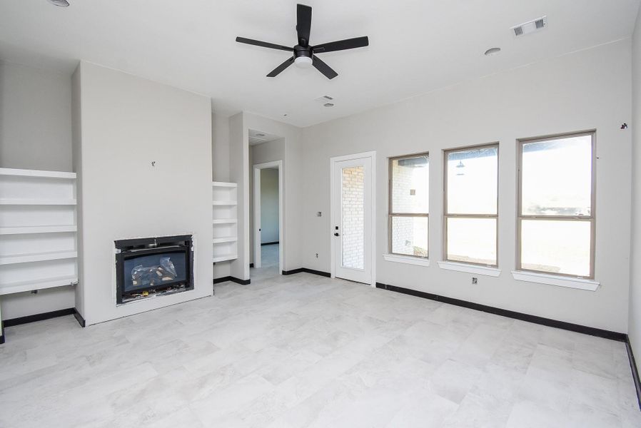 Family Room is huge with a fireplace and built-in shelves. Family Room is huge with a fireplace and built-in shelves.