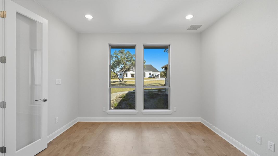 Empty room featuring light wood finished floors and recessed lighting Empty room featuring light wood finished floors and recessed lighting