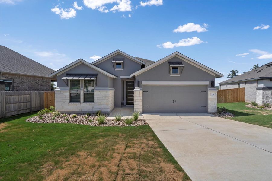 Front exterior of a new home in Crescent Bluff, Georgetown, TX, highlighting curb appeal (Image 22). Front exterior of a new home in Crescent Bluff, Georgetown, TX, highlighting curb appeal (Image 22).