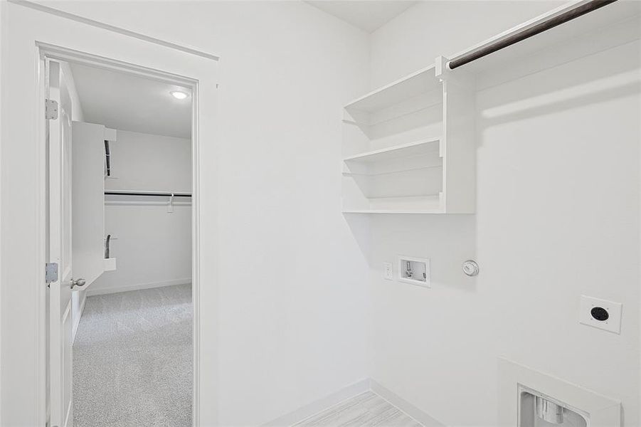 Clothes washing area featuring electric dryer hookup, hookup for a gas dryer, hookup for a washing machine, and light colored carpet