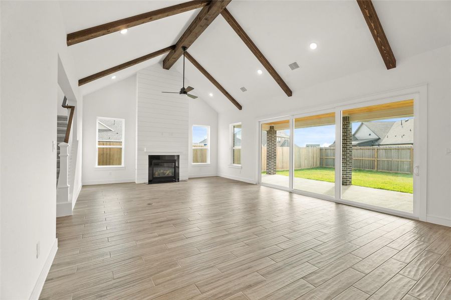 Impressive dining area and great room with stained beams (*Photo not of actual home and used for illustration purposes only.)