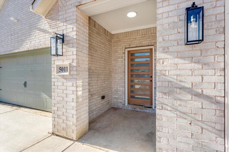 View of exterior entry with a garage