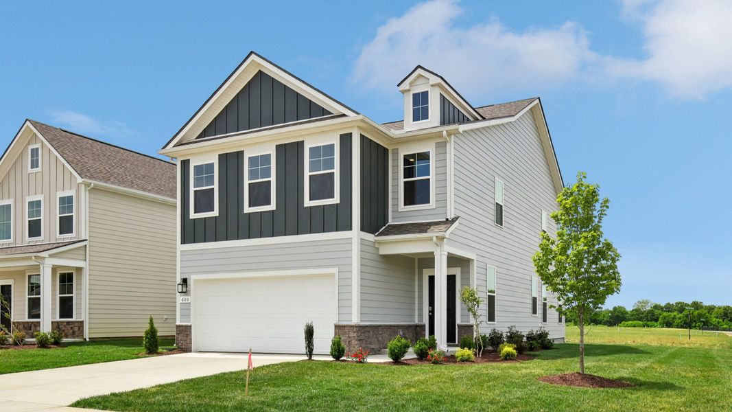 Home exterior with two tone blue siding and 2-car garage Home exterior with two tone blue siding and 2-car garage