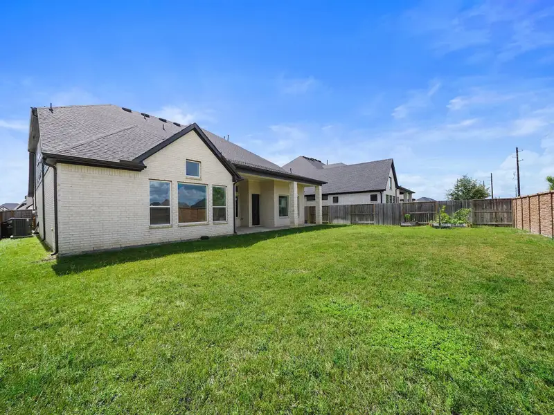 From here, you see the home’s extended patio and generous lot size, creating the perfect outdoor setting for gatherings or quiet mornings.