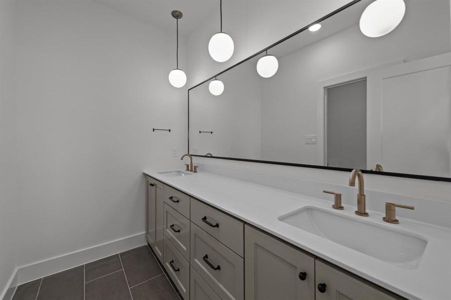 Bathroom featuring tile patterned flooring and vanity