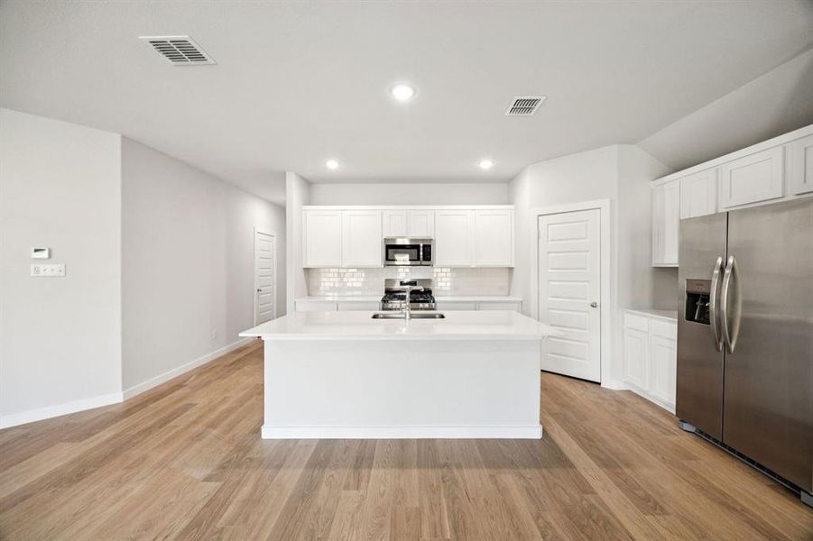 Kitchen in the Emmy II home plan by Trophy Signature Homes - REPRESENTATIVE PHOTO
