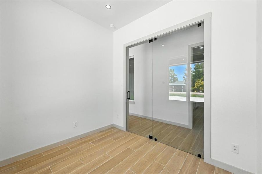 Spare room featuring wood tiled floors and recessed lighting Spare room featuring wood tiled floors and recessed lighting