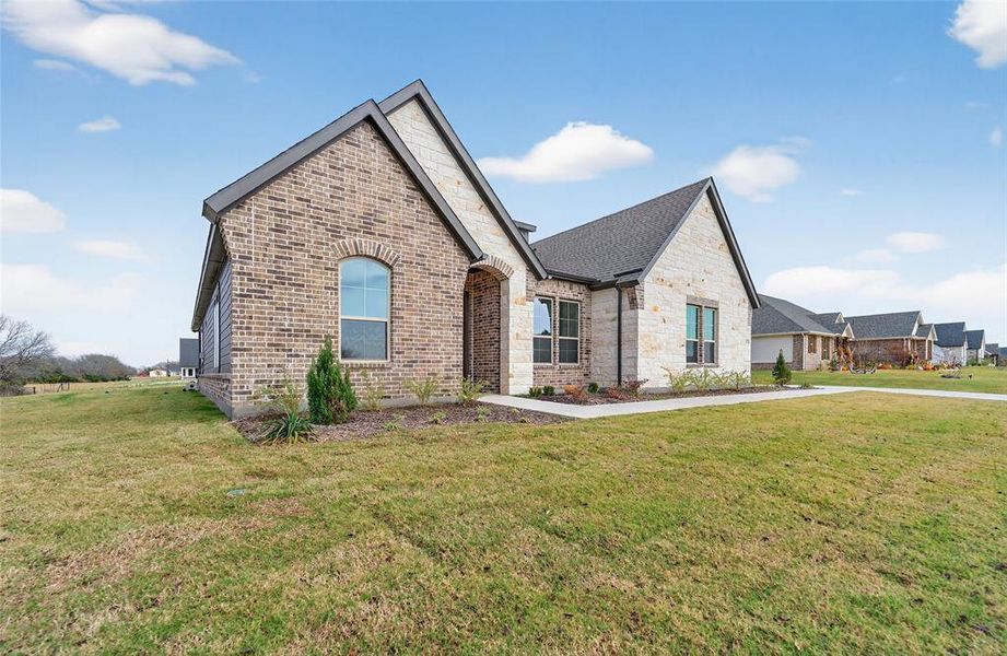 Front exterior of a new home in Nash Estates, Tom Bean, TX, highlighting curb appeal (Image 23).