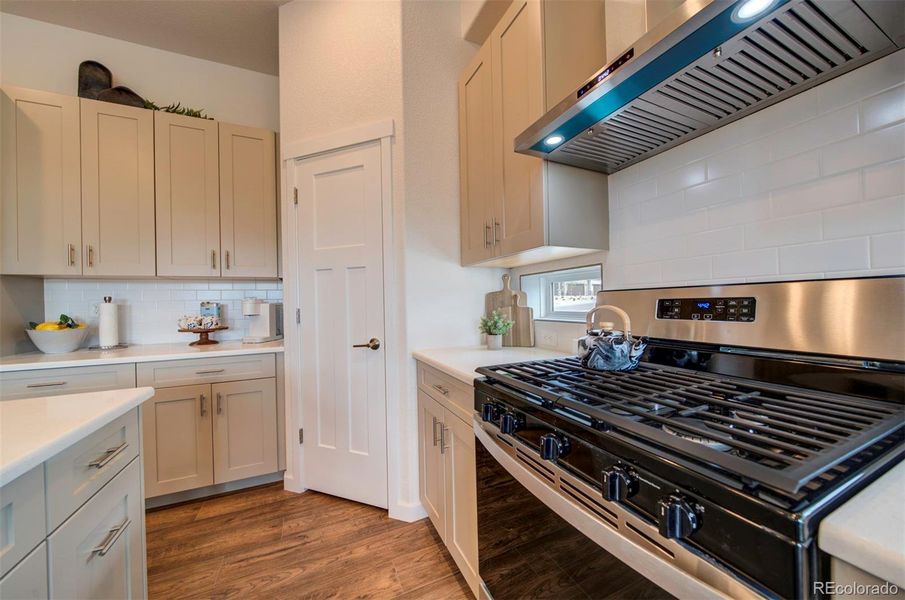 Five-burner gas range and hood are standard.