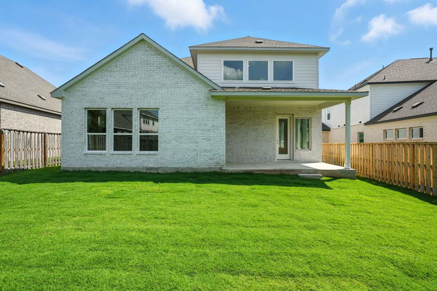 Rear view of house featuring a fenced backyard, a patio area, brick siding, and roof with shingles Rear view of house featuring a fenced backyard, a patio area, brick siding, and roof with shingles