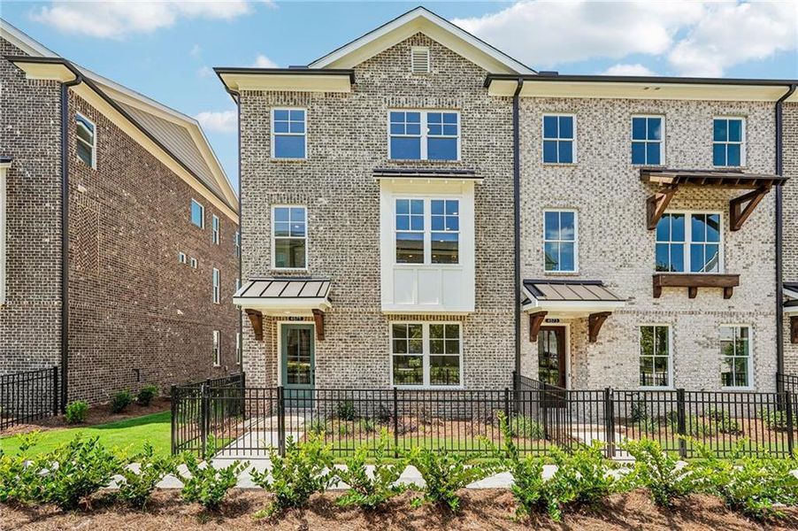 Front exterior of a new home in Waterside Townhomes, Peachtree Corners, GA, highlighting curb appeal (Image 23). Front exterior of a new home in Waterside Townhomes, Peachtree Corners, GA, highlighting curb appeal (Image 23).