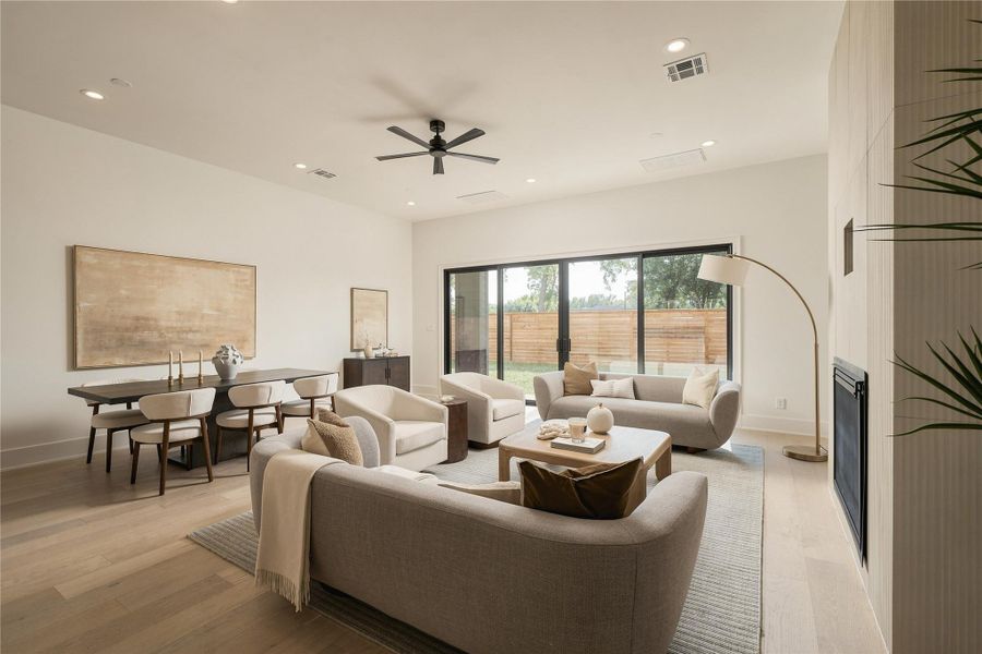 The main living room is defined by generous proportions and a gas fireplace, creating a comfortable focal point while maintaining an open connection to the dining and kitchen spaces.