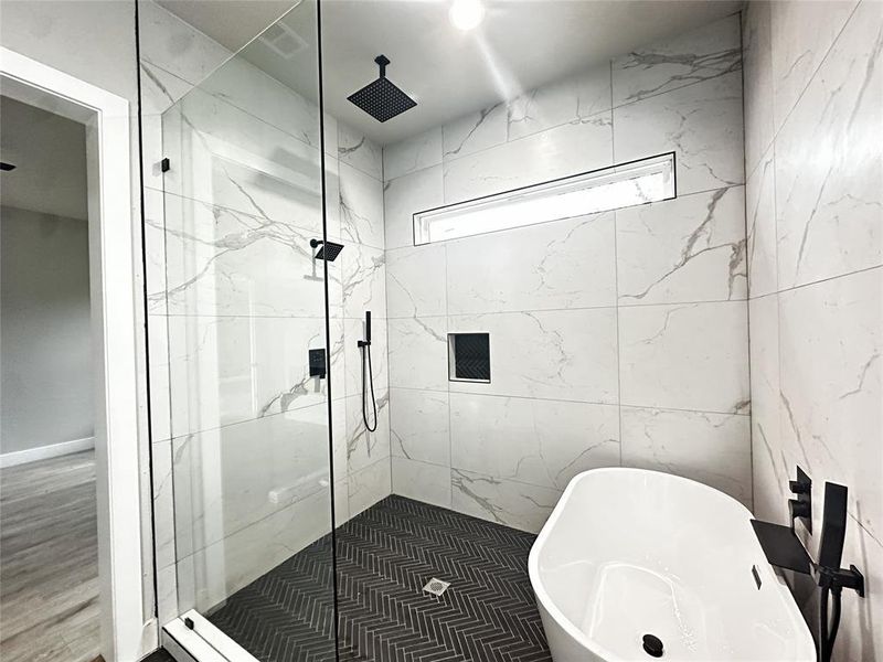 Full bathroom featuring a marble finish shower and a soaking tub Full bathroom featuring a marble finish shower and a soaking tub