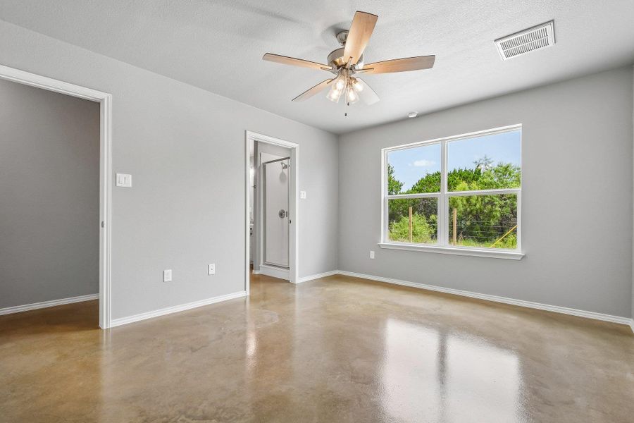 A spacious room features polished concrete floors and abundant natural light. A spacious room features polished concrete floors and abundant natural light.